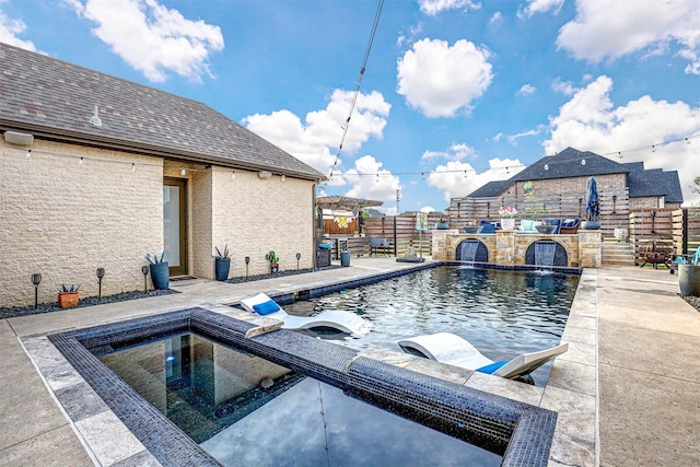 view of pool featuring pool water feature, a patio area, and a hot tub