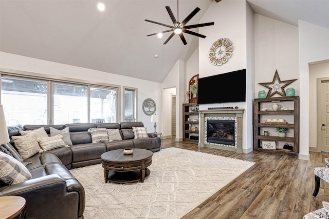 living room with ceiling fan, beamed ceiling, high vaulted ceiling, and hardwood / wood-style flooring