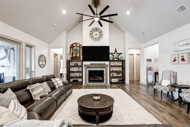 living room with hardwood / wood-style floors, ceiling fan, beamed ceiling, and high vaulted ceiling