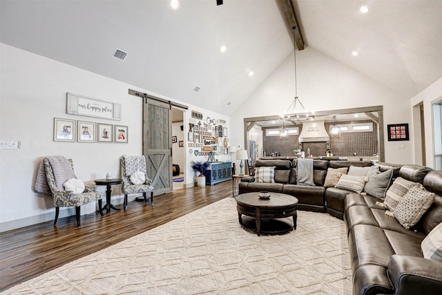 living room featuring beam ceiling, a barn door, high vaulted ceiling, and hardwood / wood-style floors