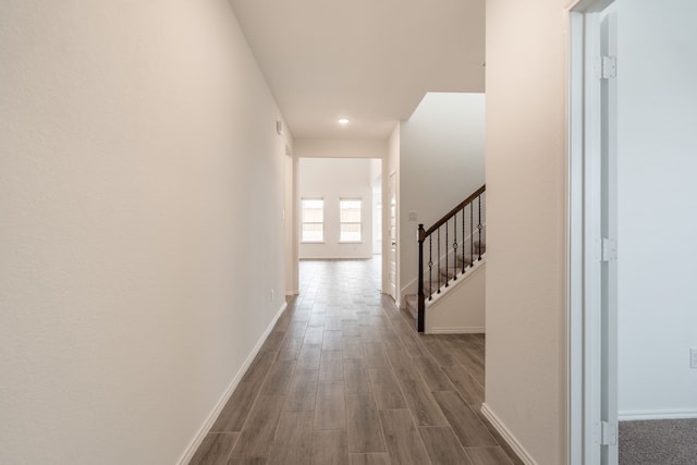 corridor with hardwood / wood-style flooring