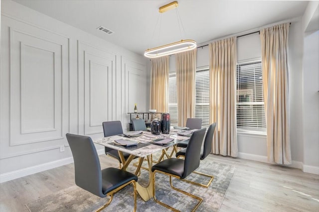 dining space featuring light wood-type flooring