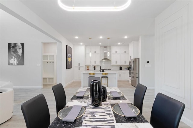 dining room featuring light hardwood / wood-style flooring and sink