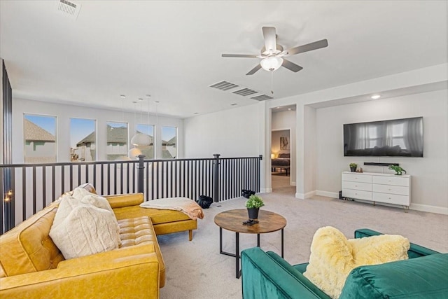 carpeted living room with ceiling fan