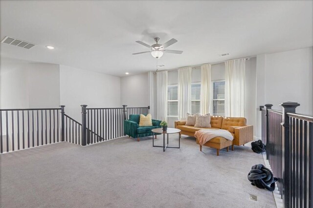 living area with carpet flooring and ceiling fan