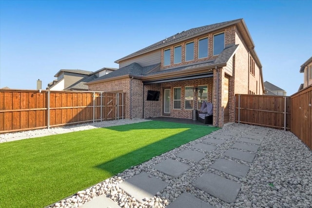 rear view of property with a lawn