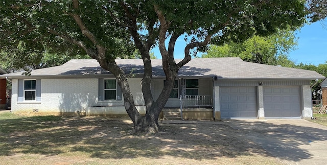 ranch-style house with covered porch and a garage