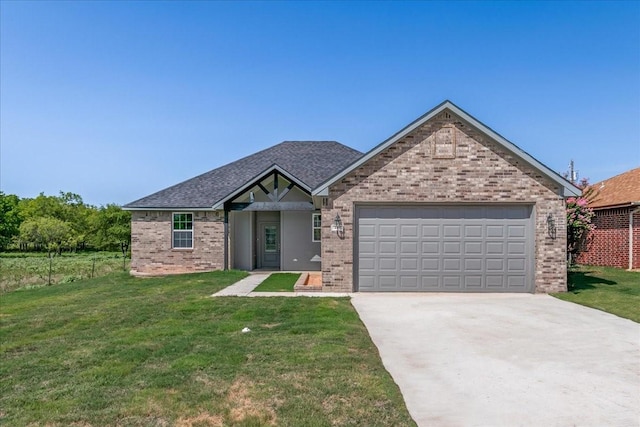 view of front of property featuring a front yard and a garage