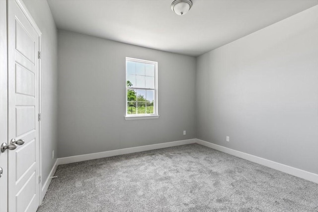 spare room featuring light colored carpet