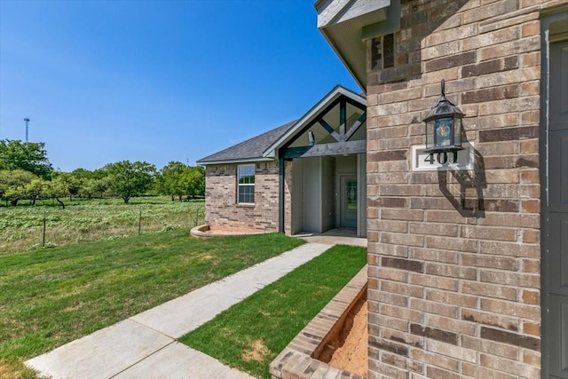 view of exterior entry with a yard