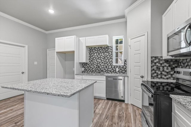 401 Mesquite Dr, Rio Vista, TX 76093 - kitchen featuring sink, white cabinetry, stainless steel appliances, light hardwood / wood-style floors, and light stone countertops
