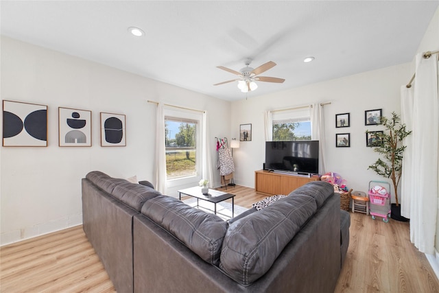 living room featuring light hardwood / wood-style floors and ceiling fan