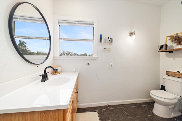 bathroom with vanity, tile patterned flooring, and toilet