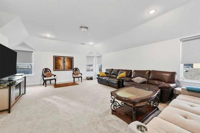 carpeted living room with lofted ceiling and a healthy amount of sunlight