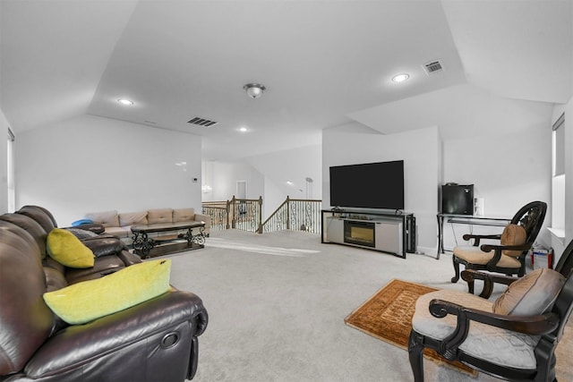 living room featuring lofted ceiling and light carpet