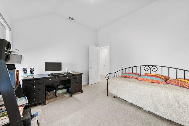 carpeted bedroom with lofted ceiling