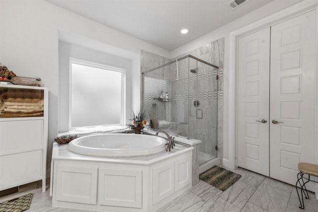 bathroom with separate shower and tub