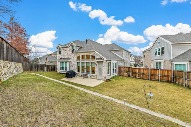 back of property with a patio and a lawn