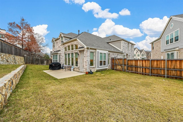 back of house featuring a patio and a lawn