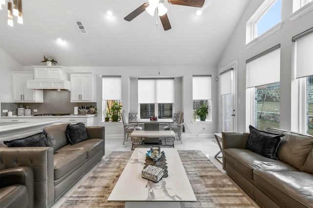 living room featuring ceiling fan and high vaulted ceiling