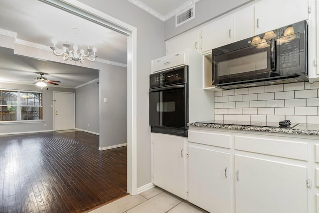 kitchen featuring black appliances, ceiling fan with notable chandelier, white cabinets, and ornamental molding