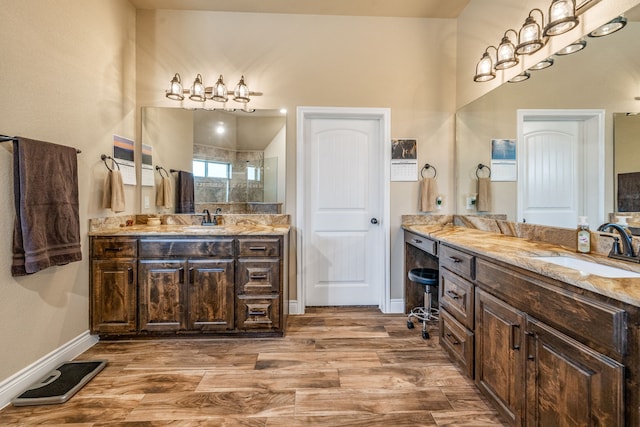 bathroom featuring hardwood / wood-style floors, vanity, and walk in shower