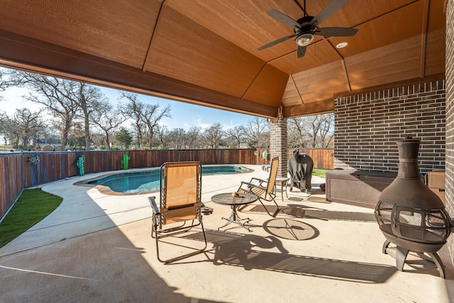 view of patio / terrace with a fenced in pool, ceiling fan, and a gazebo