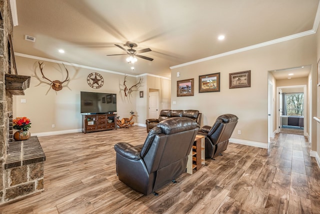 living room featuring wood-type flooring, ceiling fan, and crown molding