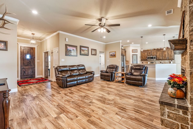 living room with ceiling fan, light hardwood / wood-style flooring, and crown molding