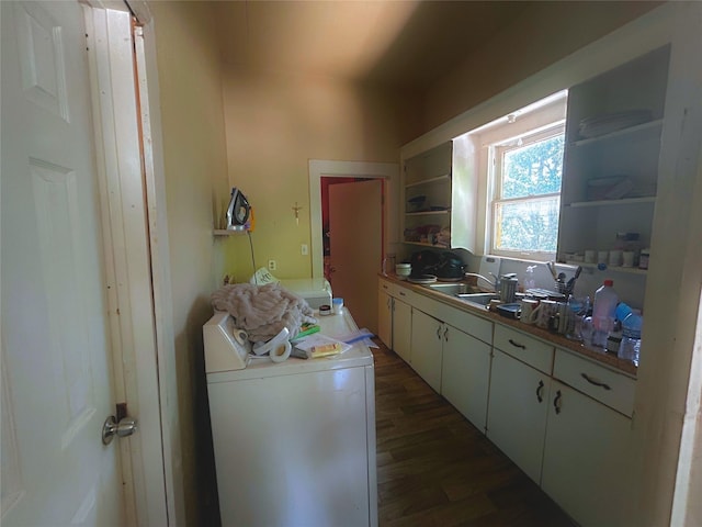 kitchen featuring washer / clothes dryer, white cabinetry, dark hardwood / wood-style flooring, and sink