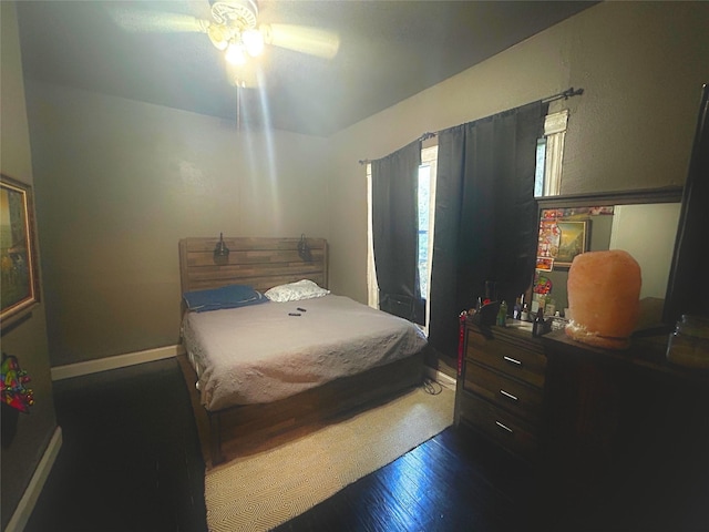 bedroom with ceiling fan and dark hardwood / wood-style floors