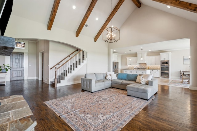 living room with beam ceiling, high vaulted ceiling, dark hardwood / wood-style floors, and an inviting chandelier