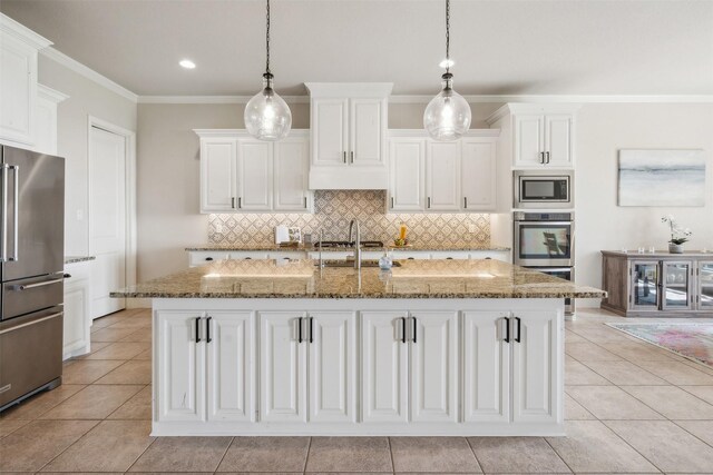 kitchen featuring white cabinets, light stone countertops, an island with sink, light tile patterned flooring, and stainless steel appliances