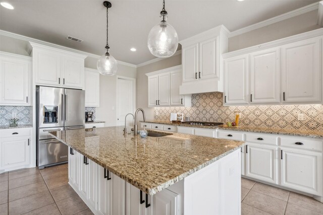 kitchen featuring a center island with sink, white cabinetry, and stainless steel appliances