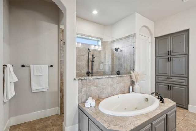 bathroom with tile patterned floors and plus walk in shower