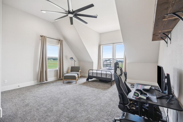 carpeted office space with plenty of natural light, ceiling fan, and vaulted ceiling