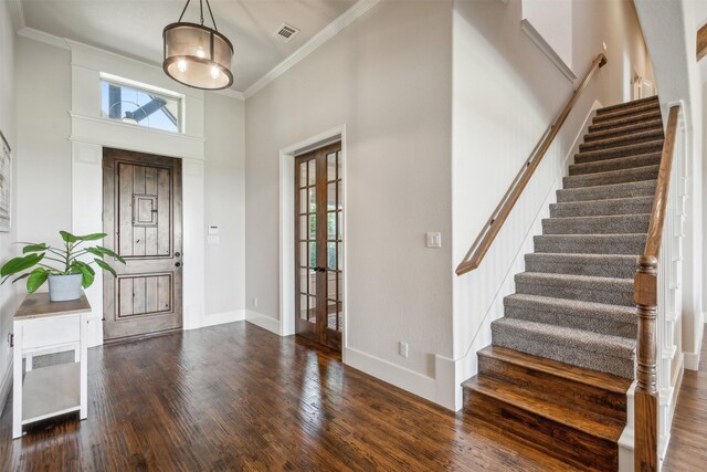 dining area with french doors, dark hardwood / wood-style flooring, a tray ceiling, and a healthy amount of sunlight