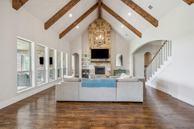 living room featuring high vaulted ceiling, a fireplace, beamed ceiling, a notable chandelier, and dark hardwood / wood-style flooring