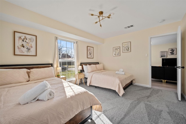 bedroom featuring carpet flooring and a notable chandelier