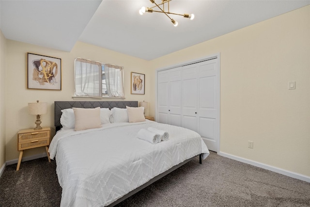 carpeted bedroom with a closet and a notable chandelier