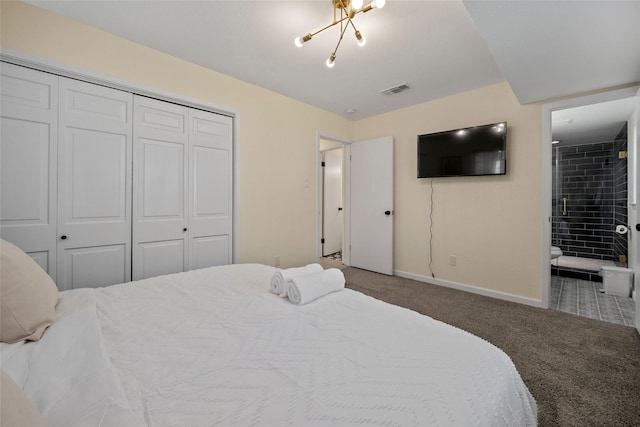 carpeted bedroom with a chandelier, connected bathroom, and a closet