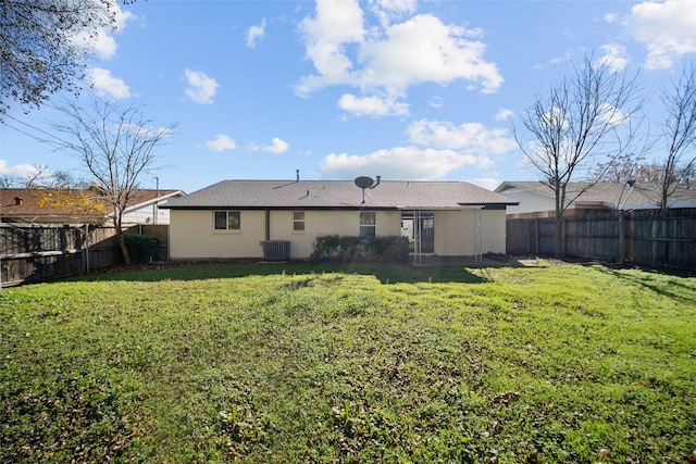 rear view of house with a yard and central air condition unit