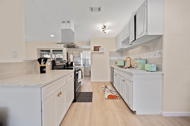 kitchen with white cabinets, sink, light hardwood / wood-style floors, island range hood, and stainless steel appliances