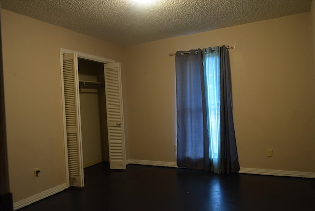 unfurnished bedroom with a closet and a textured ceiling