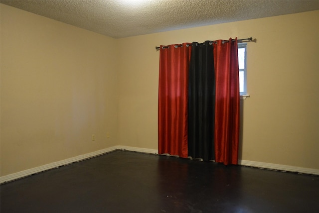 spare room with a textured ceiling