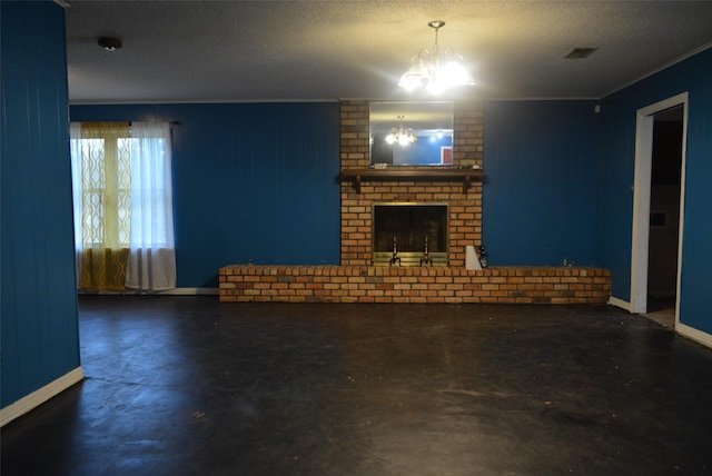 unfurnished living room featuring a chandelier, a textured ceiling, and a brick fireplace