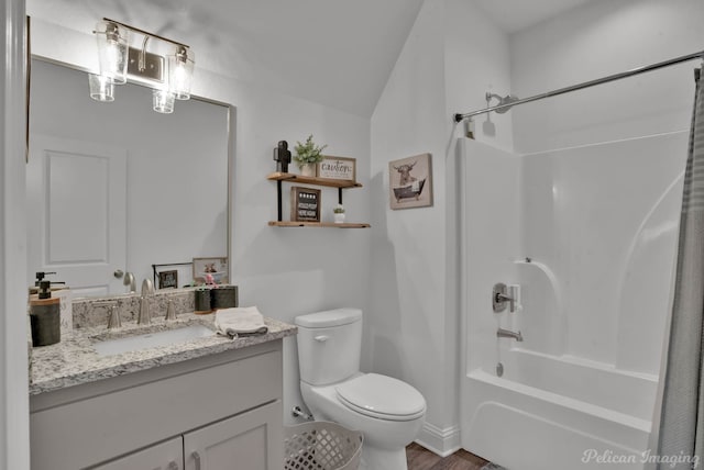 full bathroom with hardwood / wood-style floors, vanity, toilet, and  shower combination