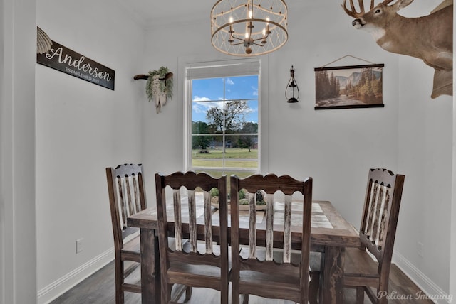 dining area featuring an inviting chandelier, dark wood-type flooring, and ornamental molding