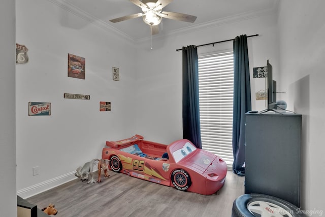 bedroom with ornamental molding, wood-type flooring, and ceiling fan