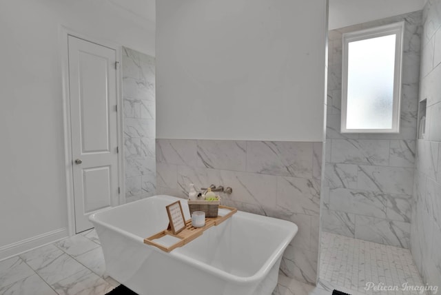 bathroom with tile walls and a tub